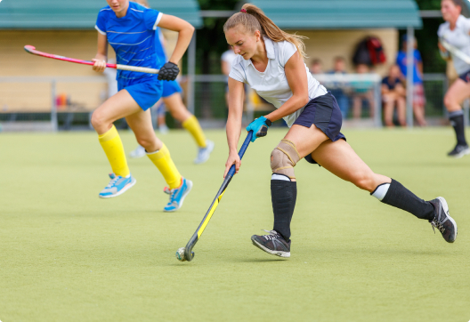 Girls playing field hockey