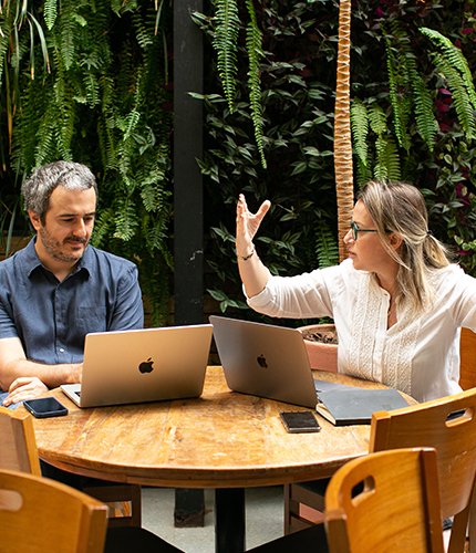 Employees talking about a project outdoors