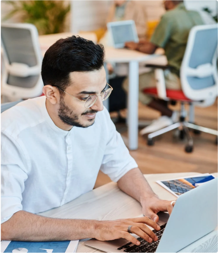 An employee works on their laptop