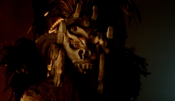 A masked monster stares in the dark
