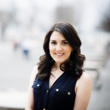Tory Lariar in front of a blurred white background