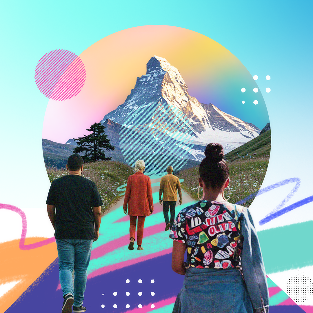 People walking down a colorful road towards a mountain and colorful sunset