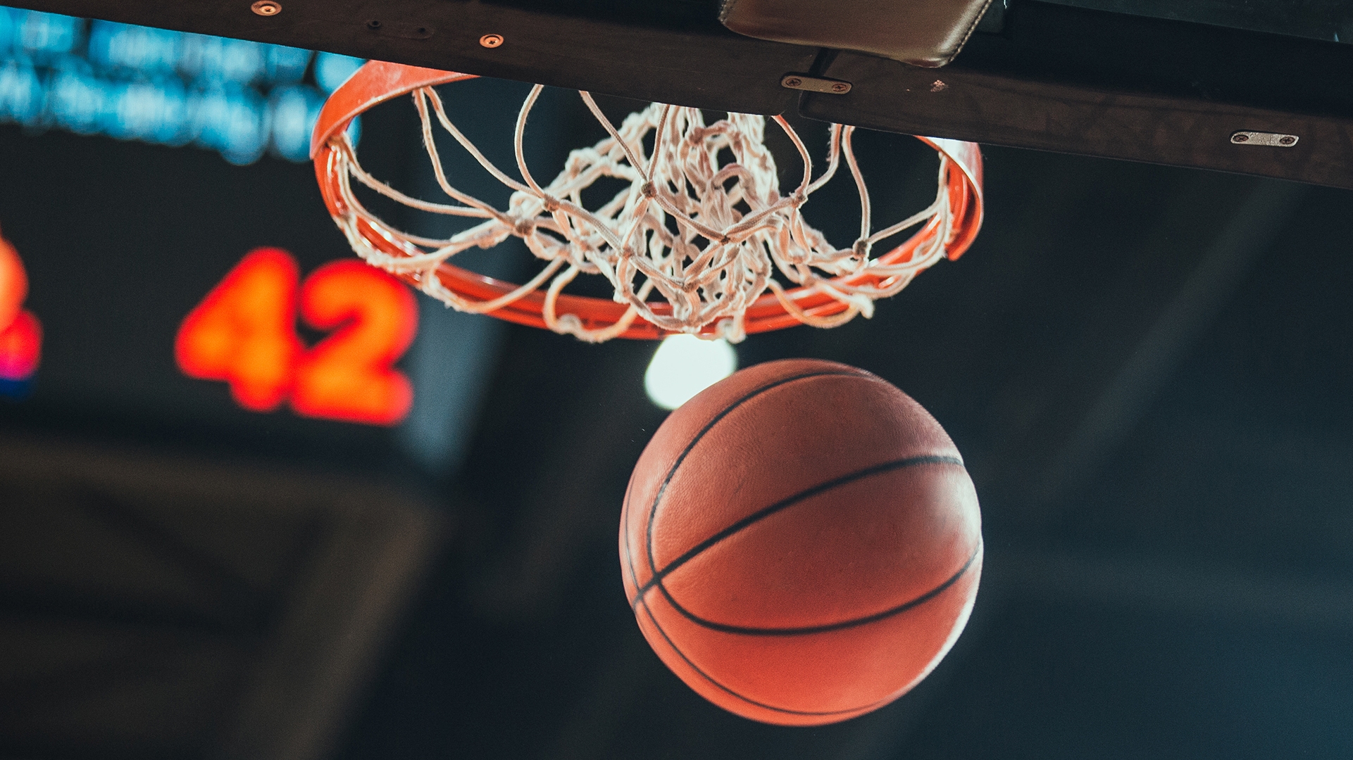 A basketball goes through a basketball hoop