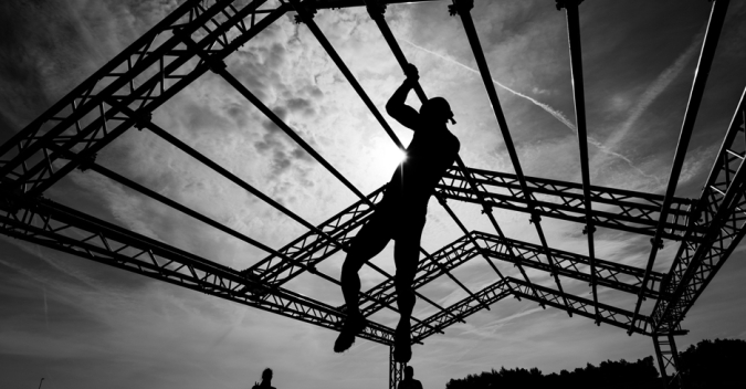 A person doing crossfit climbing a rope