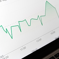 A line graph spiking and falling on a laptop