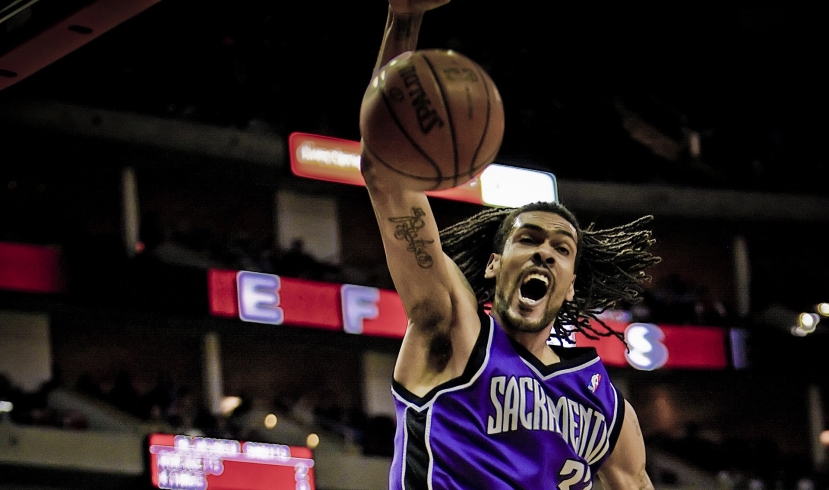 A person slamdunking a basketball